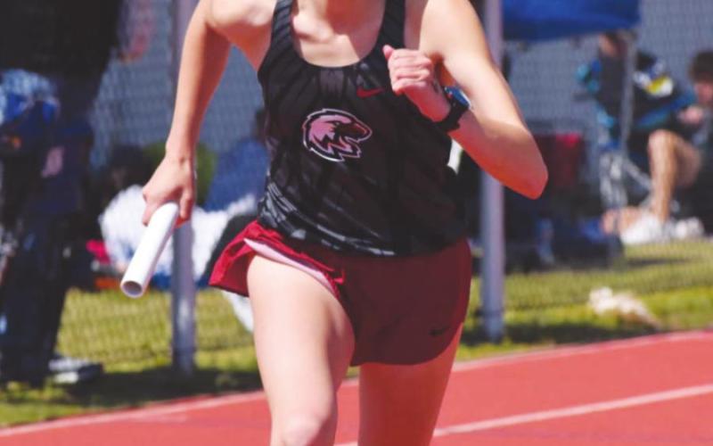 Below: Riley Coleman competes during a track meet in Watonga on Saturday, April 24. Coleman won the 1,600m run and helped the Lady Eagles win several relay events. (Photos provided by Brenda Lee Geels)