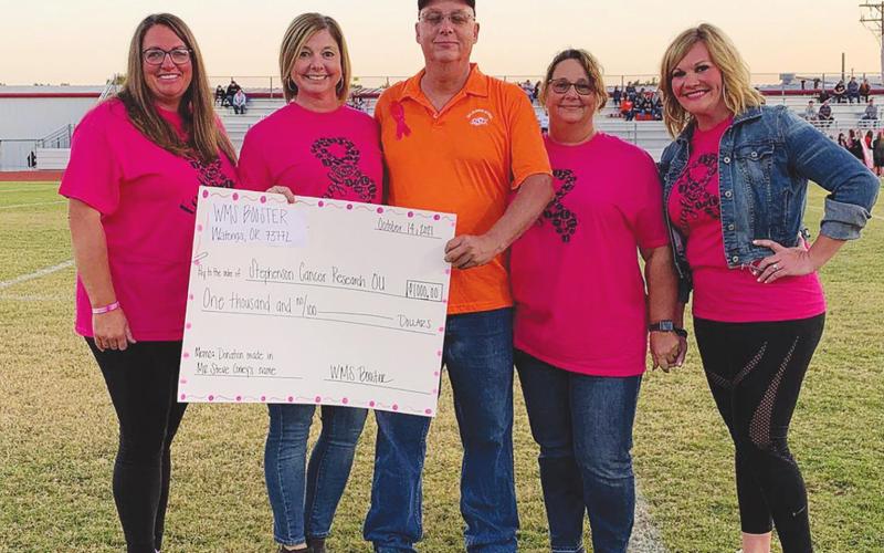 Watonga Public Schools honored Breast Cancer Awareness Month Thursday with a "Pink Out" fundraiser to benefit cancer research at OU Medical Center. The district also honored local man Steve Coney, who is currently battling cancer, before Watonga's game against Crescent. From left: Kelly Manke, Michelle Hilterbran, Steve Coney, Kim Coney and Mindy Wigington. (Photo provided by Kyle Hilterbran)