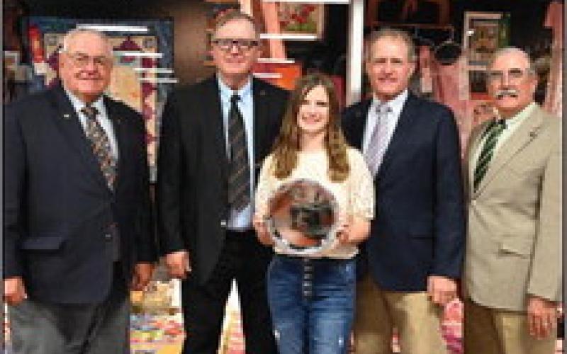 Avery Fisher from Okeene, OK, receives her Champion bread tray and first place ribbon in the Other Wheat Bread category at the 2022 State Fair “Best of Wheat” Bread Baking Contest with her Challah Bread recipe. Oklahoma Wheat Commissioners Don Schieber, secretary-treasurer, Ponca City; RJ Parrish, District I, Hunter; Jerry Wiebe, District 2, Hooker and David Gammill, vice-chairman, Chattanooga presents her silver tray award.