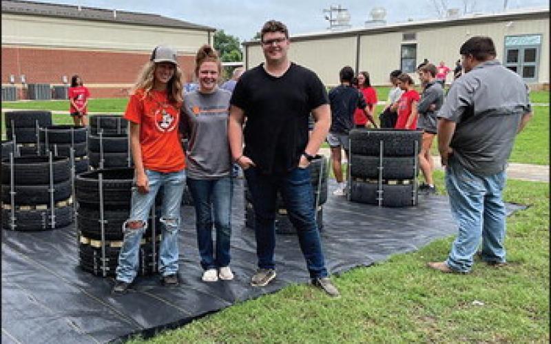 Wetumka High School students work on building recycled tire gardens. They’ve harvested radishes and are currently growing various types of lettuces. (Photo provided)