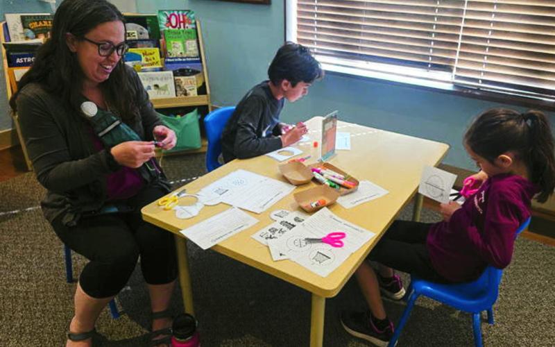 A family participating in educational and fun Homeschool Day activities.