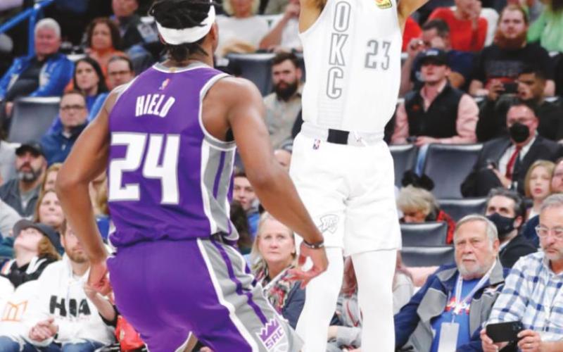 Oklahoma City Thunder guard Tre Mann shoots a 3-point basket over Sacramento Kings guard Buddy Hield. Photo: Alonzo Adams-USA TODAY Sports