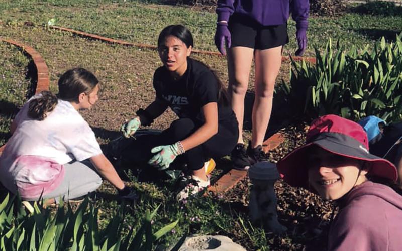 Students Clean Up Chapel Flowerbeds