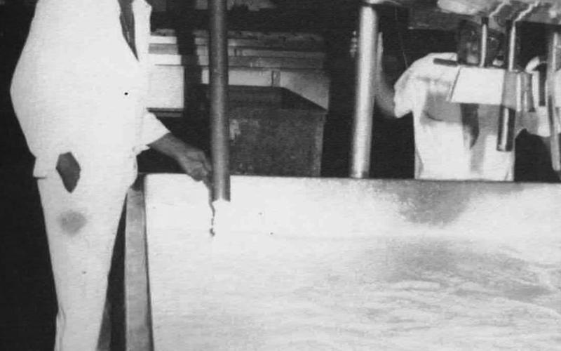A worker fills a stainless steel vat with pasteurized milk before he ads rennet and food coloring in the process of making cheese at the old Watonga Cheese Factory
