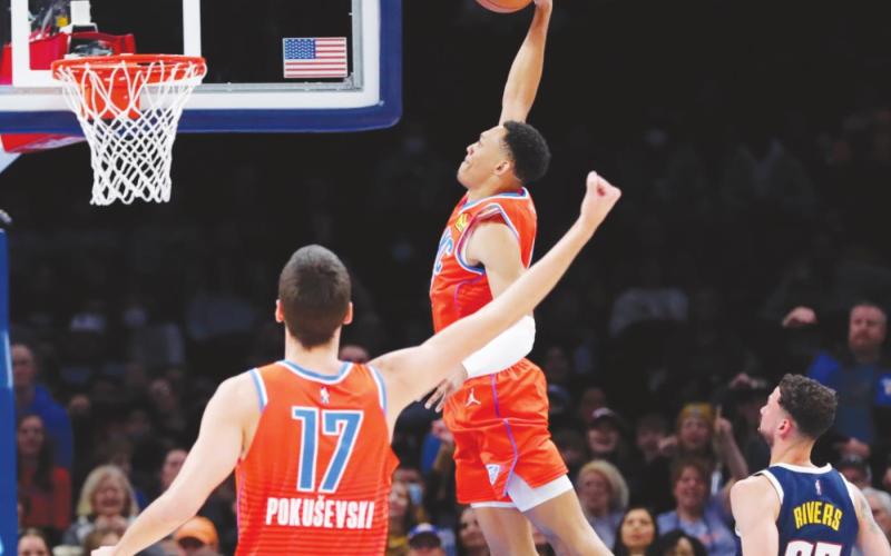 Oklahoma City Thunder forward Darius Bazley goes up for a dunk ahead of Denver Nuggets guard Austin Rivers as Thunder center Aleksej Pokusevski looks on during the second quarter at Paycom Center. (Alonzo Adams-USA TODAY Sports)