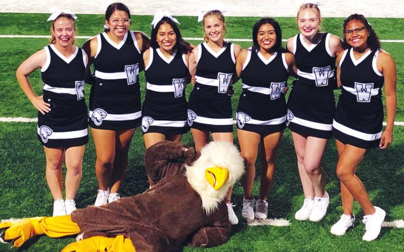 (Above) The Watonga High School varsity cheerleaders pose for a picture on the field with the Eagles’ mascot on Sept. 13, 2019, prior to Watonga’s 22-14 victory over the Alva Goldbugs in a game held at Northwestern Oklahoma State University. Tryouts for the incoming 2020-21 varsity squad will be held from July 15-18. Photo Courtesy of Becky Cope The Geary Star