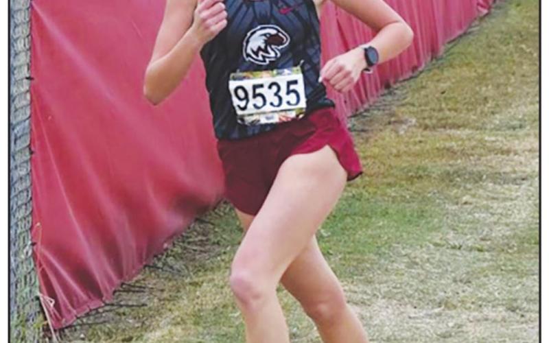Riley Coleman running in the regional meet where she was regional champion.