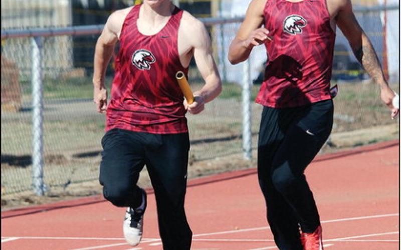 Above, Nick Walker has taken the baton from Chris Sanders and speeds off down the track.