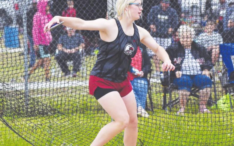 Left: Josey Rinehart competes in the discus throw in Okemah. Rinehart finished the event in second place with a top throw of 104’7”.