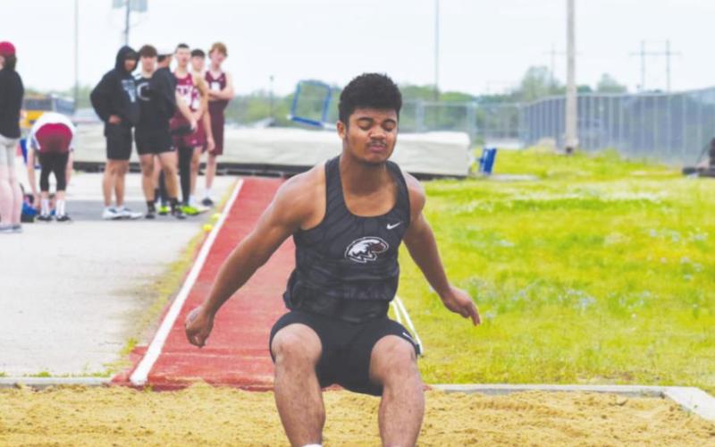 Below: Joe Jackson competes in the long jump at the Okemah track and field meet Saturday. Jackson’s top jump was 18’2.75”. (Photos provided by Brenda Geels)