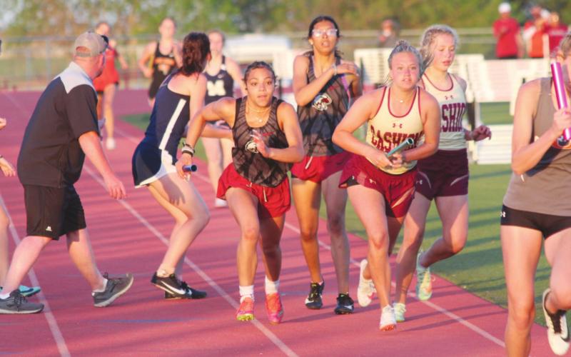 Watonga's Shawn Johnson takes the handoff from Whitley Johnson during the 1600m relay event at Cherokee on Saturday, April 30.