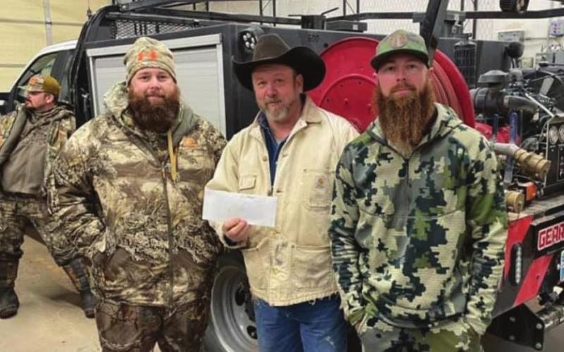 Winners of this year's hunt Andy Smith (left) and Chase Didier (right) as they received their prize money from Stephen Havener (center). (Photo provided by Geary Fire-Rescue)