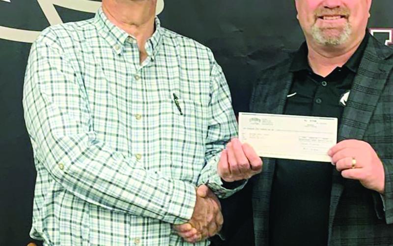 Above: Watonga Elementary Principal Ashley Riley and Watonga Superintendent Kyle Hilterbran accepting a $1,250 donation from Public Service Company of Oklahoma (PSO). The donation is for the elementary school STEM Lab. PSO owns the Traverse Wind Farm southwest of Watonga. At Left: Superintendent Kyle Hilterbran accepts a donation to Watonga Schools from Cimarron Electric Co.