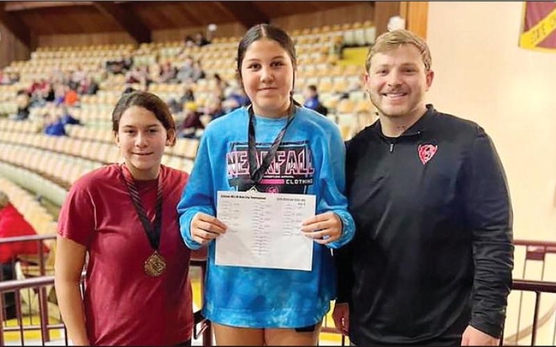 Brock Daniels coached Hollis Harrall to first in her wrestling division and Maddy Evey to third in her division at a Jan. 20 meet. Photo courtesy Geary Public Schools