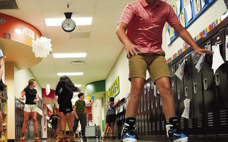 (ABOVE and AT RIGHT) The sixth grade class kept the tradition alive by skating through the elementary halls one last time as they finish out their final month before the move to the JH/HS building.