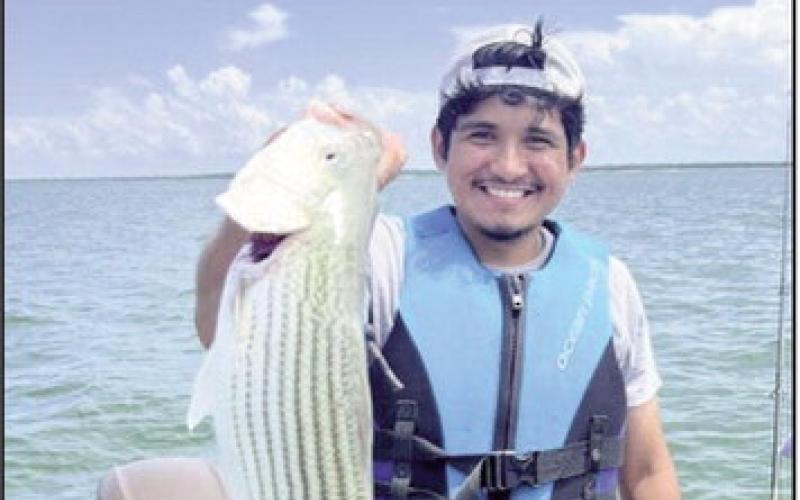 (ABOVE) Issac L. with striped bass caught at Lake Texoma. Share your photos with us!