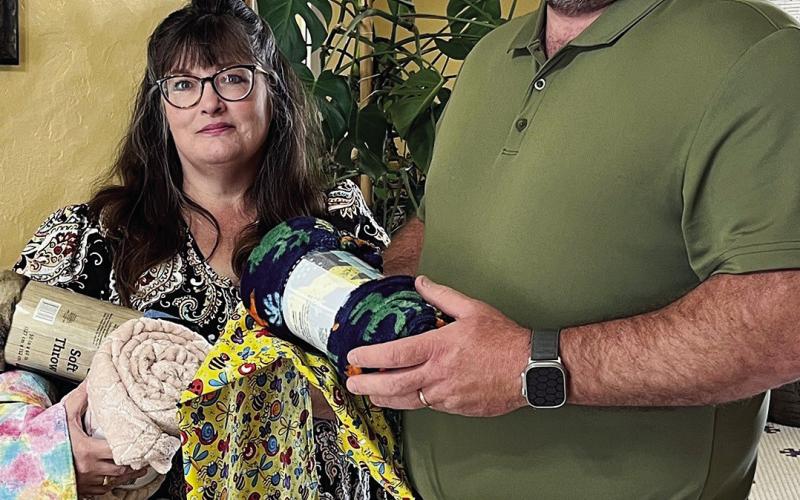 As part of OHCE Week, the Blaine County OHCE Association presented the sheriff’s office with 26 blankets and pillowcases for children in need that they may come across in their line of work. Pictured making the presentation to Sheriff Travis Daugherty is Mary Larson, County OHCE President.