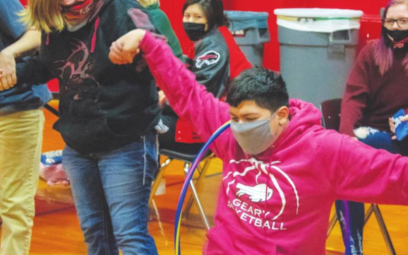 Pedro Covarrubias attempts to get a hula hoop to another student during Spirit Week activities. (Photo provided)