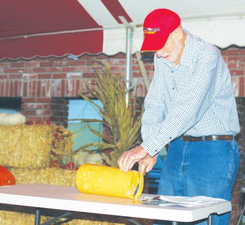 Former Watonga Mayor Gary Olsen cuts the cheese – a block of Watonga cheese, that is – in 2018 to officially kick off the festival. The ceremonial cutting of cheese will take place at 6:00 p.m. Thursday Oct. 7 at Centennial Park.