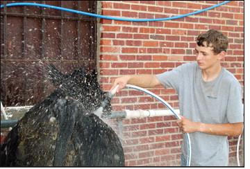Grant Robison washes his steer before entering the show ring at the Blaine County Fair livestock show in August.