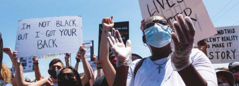 A woman cheers at a Black Lives Matter Protest in northeast Oklahoma City on May 31. The gathering was prompted by the killing of George Floyd, a black man in Minnesota. (Whitney Bryen/Oklahoma Watch)