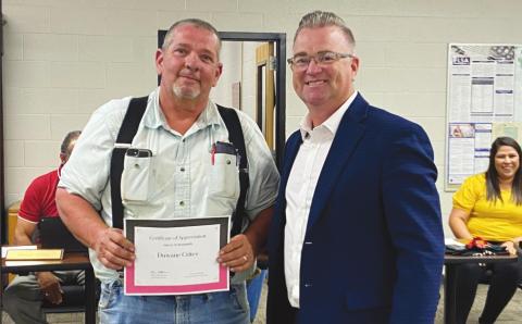 Watonga Superintendent Kyle Hilterbran (right) presents a certificate of appreciation to Duwane Crites for his efforts over the summer. Crites led extensive remodeling projects at all Watonga school campuses.