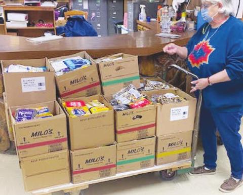 Opal Clyden wheels out food and goods boxes ready for Senior Nutrition day. (Photo provided by Carla Flynn)
