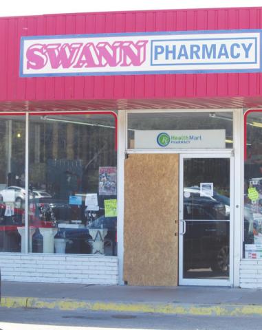A door at Swann Pharmacy is boarded up one week after thieves broke in and stole prescription drugs on Tuesday, Aug. 24, 2021.