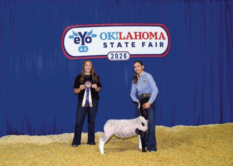 Mae Scheihing, an 8th grader at Watonga Middle School, and her grand champion hair sheep at the Oklahoma State Fair.