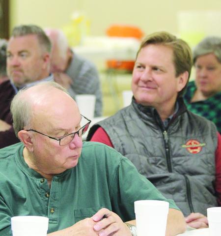 Bidders including Todd Lafferty of Wheeler Bros. and Superintendent Kyle Hilterbran keep an eye on the prices as they are called out.