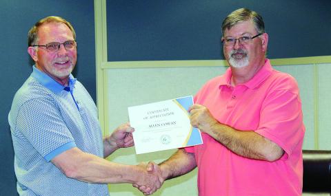 Mayor Bill Seitter presents a certificate of appreciation Tuesday evening to outgoing Watonga City Council member Allen Cowan. Cowan did not run for re-election after five years on council. He said it had been a real privilege to serve the city as it was changing and beginning to gain ground on modernization.