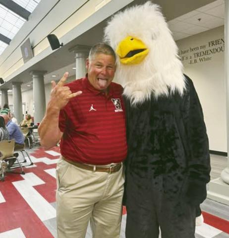 (ABOVE) Watonga Athletic Director Kirk Wilson hams it up Thursday with the Eagle mascot during teacher in-service days at the high school. Meanwhile, at Geary High School some goats showed up for the first day of school
