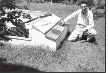 George Wint was one of the first graduates of the OSU Fish and Wildlife Research Unit. Here, he sits alongside a quail coop that he used for his research on the release of pen-raised quail for increasing wild populations. Wint later became director of the Oklahoma Department of Wildlife Conservation in the 1970s.