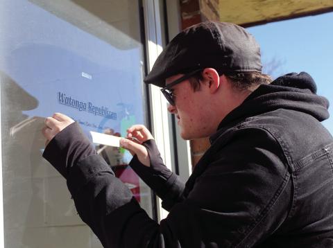 Gunnar Larson, a student at Chisholm Trail Technology Center, applies new door grahics to the offices of the Watonga Republican. After 76 years downtown, the paper has relocated to North Harmon Avenue.