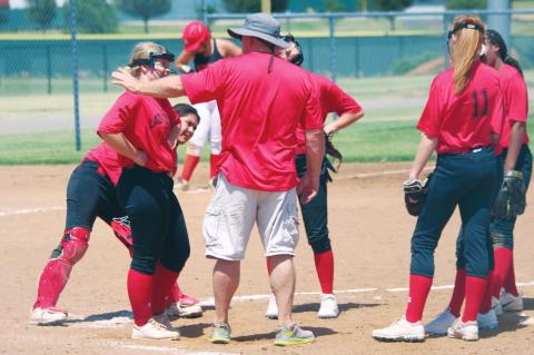 (Above) Geary High School varsity fast-pitch first-year head coach Rick Scott talks with his Lady Bison infielders on Tuesday, June 16 during a Hinton Summer League softball scrimmage against Navajo High School. The Lady Bison took the field for live-action softball for the first time this summer at the Kiwanis Sports Complex in Hinton. Photos by Andrew Salmi The Geary Star