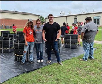 Wetumka High School students work on building recycled tire gardens. They’ve harvested radishes and are currently growing various types of lettuces. (Photo provided)