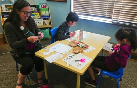 A family participating in educational and fun Homeschool Day activities.