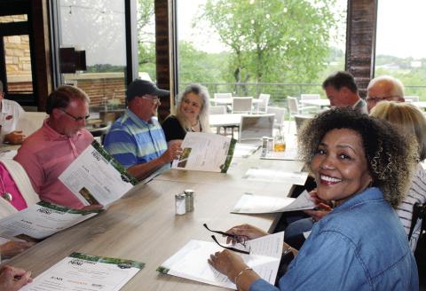 Members of Watonga City Council and the Oklahoma Legislature view the menu on opening day at the Lookout Kitchen at Roman Nose State Park, May 23, 2023