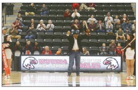 A big crowd was on hand Friday for the grand opening of the new gym at Watonga High School. District school board president Dwight McGee gives a victorious fist pump after cutting the ribbon held by cheerleaders Kylie Hilterbran( L) and Sydnee Lake.(R) PHOTO BY CONNIE BURCHAM