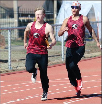 Above, Nick Walker has taken the baton from Chris Sanders and speeds off down the track.