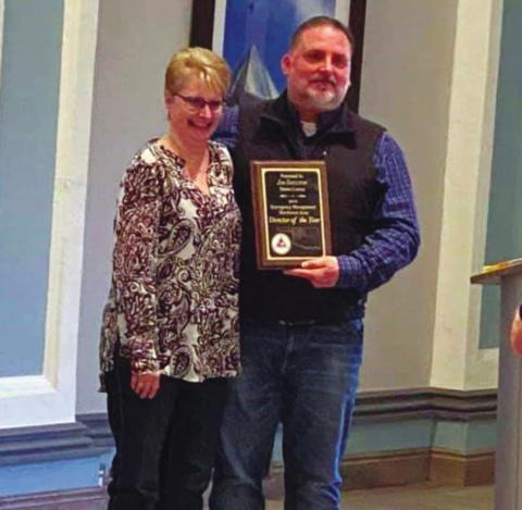 Jim Shelton, Blaine County Emergency Manager, accepts a plaque from Lynn Gould. Shelton was awarded March 5 as the Northwestern Oklahoma Emergency Manager of the Year at the Northwestern Oklahoma Emergency Management Workshop in Enid. He will go on to compete for the state award, which will be made in August. Lynn Gould I Watonga Republican