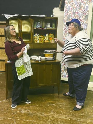 Florence Unger (Kim Coney) flinches as Olive Madison (Amy Adams) gives her the finger shake during a rehearsal of the Odd Couple Female Version. Tehe play will be presented April 5-7 at the Liberty Theatrer.