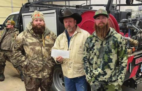 Winners of this year's hunt Andy Smith (left) and Chase Didier (right) as they received their prize money from Stephen Havener (center). (Photo provided by Geary Fire-Rescue)